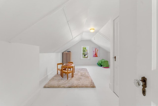 additional living space featuring vaulted ceiling and baseboards