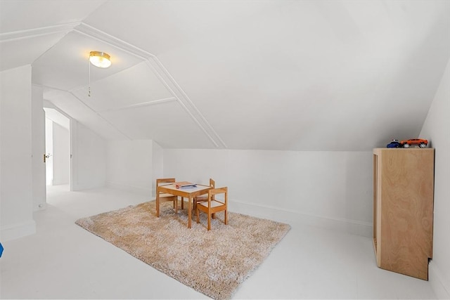 additional living space with lofted ceiling and baseboards