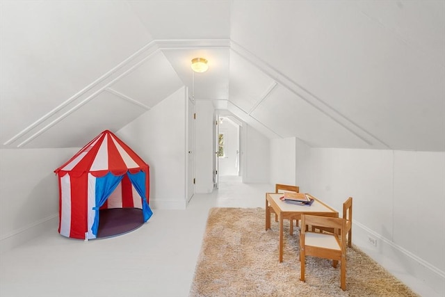 additional living space with lofted ceiling and carpet flooring