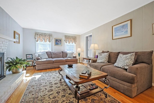 living room with a fireplace and wood finished floors