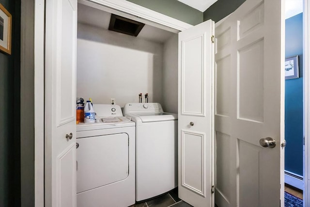 laundry area with laundry area, separate washer and dryer, and dark tile patterned floors