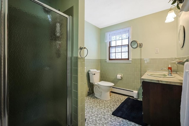 bathroom with tile walls, a baseboard radiator, vanity, a shower stall, and tile patterned floors