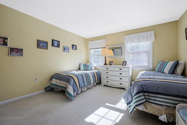 bedroom with light carpet and baseboards