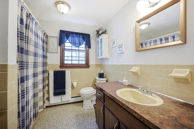 full bath featuring tile walls, toilet, wainscoting, vanity, and tile patterned flooring