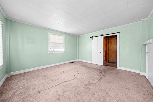 62 County St, Taunton, MA 02780 - unfurnished bedroom featuring crown molding, carpet floors, baseboards, and a barn door