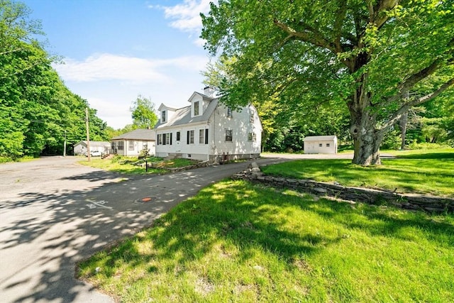 62 County St, Taunton, MA 02780 - cape cod home featuring asphalt driveway, an outbuilding, and a front lawn