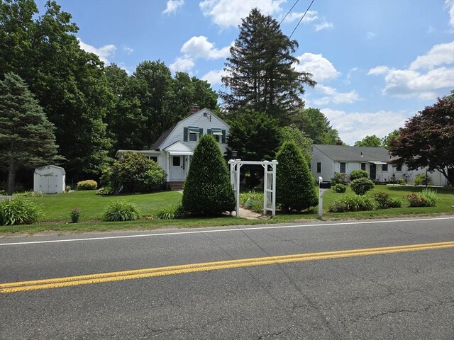 38 N W St, Agawam, MA 01030 - view of front of home featuring a gambrel roof, a front yard, and a chimney