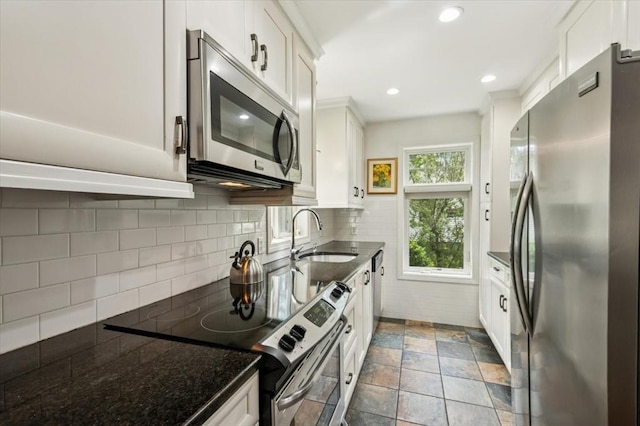 38 N W St, Agawam, MA 01030 - kitchen featuring appliances with stainless steel finishes, white cabinets, decorative backsplash, and recessed lighting