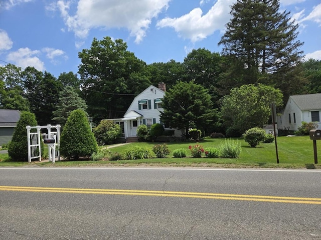 38 N W St, Agawam, MA 01030 - view of front of house with a gambrel roof, a front yard, and a chimney
