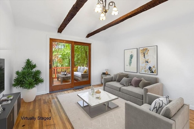 living room with hardwood / wood-style floors, a chandelier, and baseboards