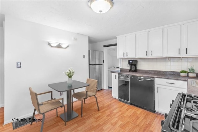 kitchen with freestanding refrigerator, black dishwasher, tasteful backsplash, white cabinetry, and a textured ceiling