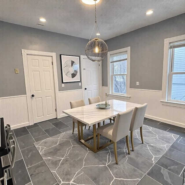 dining room with recessed lighting, visible vents, and wainscoting