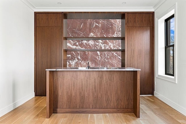 bar featuring wet bar, a healthy amount of sunlight, and light wood-style floors