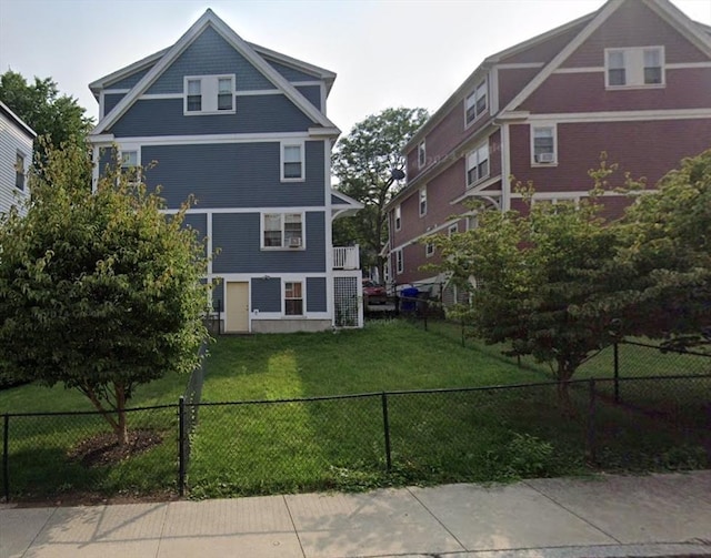 back of house with a lawn