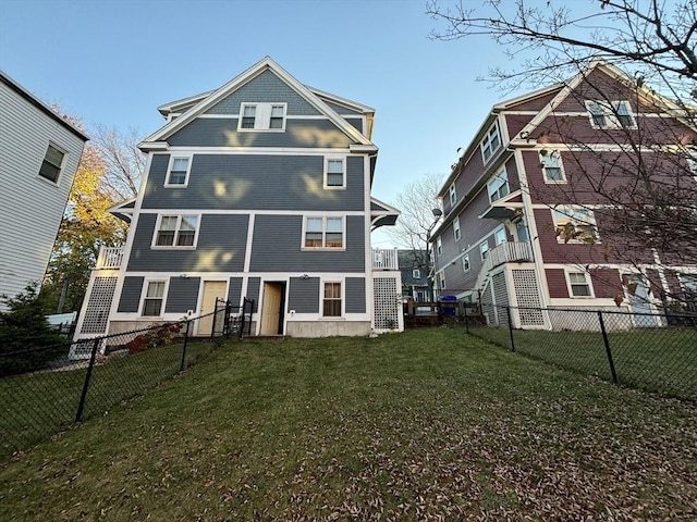 rear view of property featuring a yard