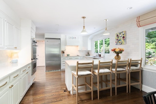 130 Hickory Rd, Weston, MA 02493 - kitchen with appliances with stainless steel finishes, white cabinetry, light countertops, decorative backsplash, and recessed lighting