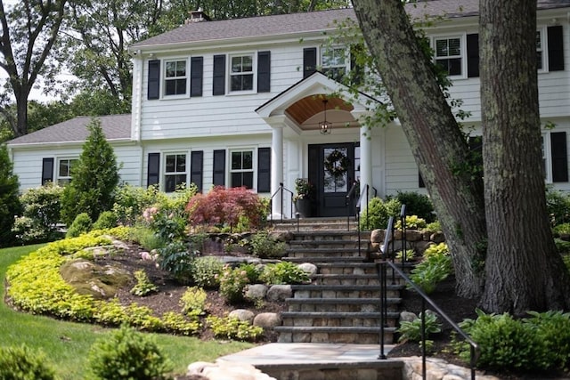 130 Hickory Rd, Weston, MA 02493 - colonial-style house featuring a chimney and roof with shingles