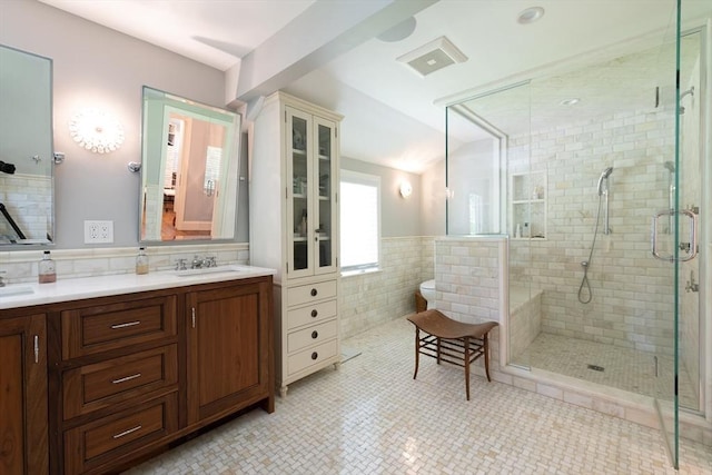 130 Hickory Rd, Weston, MA 02493 - bathroom featuring tile walls, a stall shower, double vanity, and a wainscoted wall