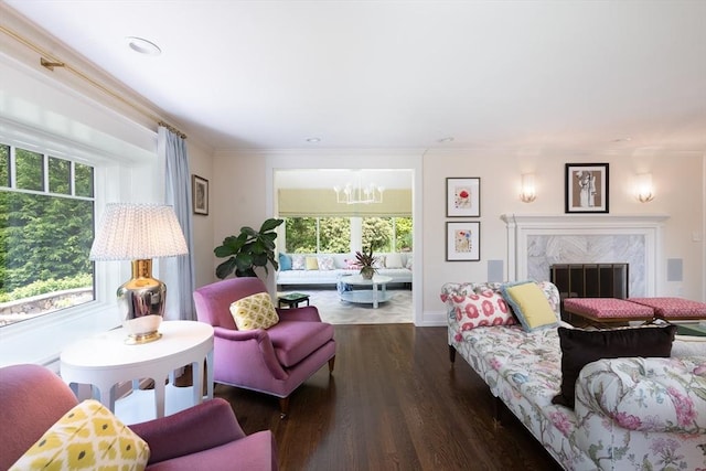 130 Hickory Rd, Weston, MA 02493 - living area with healthy amount of natural light, a chandelier, wood finished floors, ornamental molding, and a fireplace