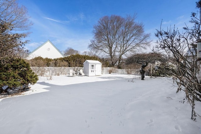 yard covered in snow with a storage unit