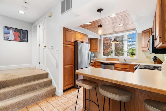 64 Prospect St Unit B, Marblehead, MA 01945 - kitchen with stainless steel appliances, a sink, a peninsula, recessed lighting, and light countertops