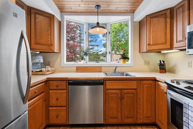 64 Prospect St Unit B, Marblehead, MA 01945 - kitchen featuring appliances with stainless steel finishes, a sink, brown cabinetry, wood ceiling, and light countertops