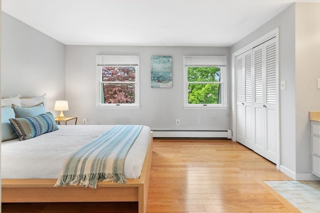 64 Prospect St Unit B, Marblehead, MA 01945 - bedroom featuring baseboard heating, light wood-style floors, a closet, and baseboards