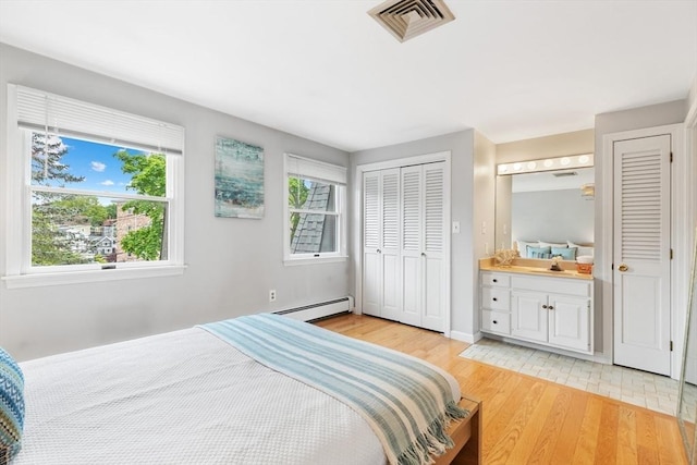 64 Prospect St Unit B, Marblehead, MA 01945 - bedroom with a baseboard radiator, light wood-style flooring, multiple windows, and a closet