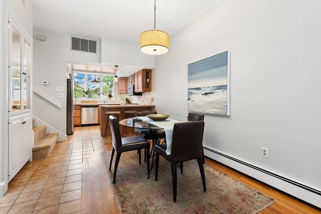 64 Prospect St Unit B, Marblehead, MA 01945 - dining space with a baseboard heating unit, light wood-type flooring, and stairway