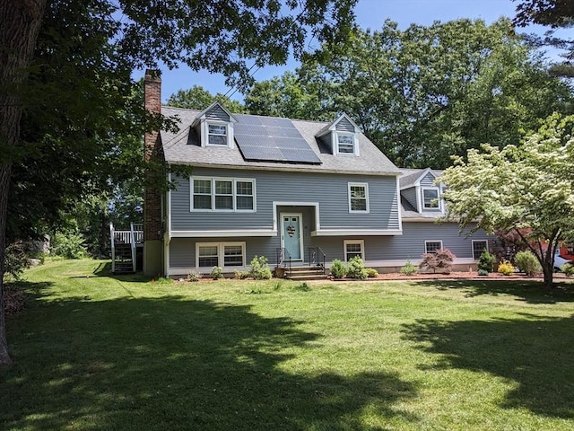 38 Pearson Dr, Newbury, MA 01922 - raised ranch featuring roof mounted solar panels, a chimney, and a front lawn