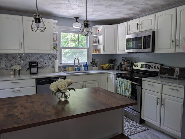 38 Pearson Dr, Newbury, MA 01922 - kitchen featuring stainless steel appliances, wooden counters, open shelves, white cabinetry, and a textured ceiling