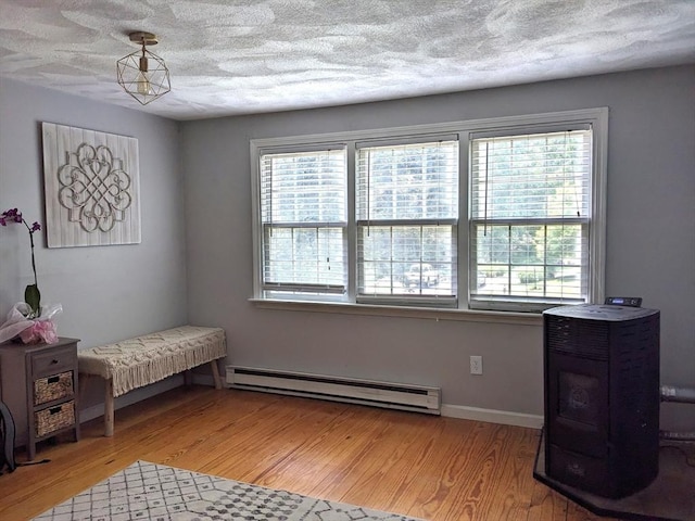 38 Pearson Dr, Newbury, MA 01922 - living area with a baseboard heating unit, plenty of natural light, light wood finished floors, and a textured ceiling