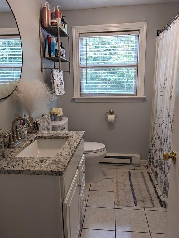 38 Pearson Dr, Newbury, MA 01922 - bathroom with a baseboard heating unit, vanity, tile patterned floors, and curtained shower