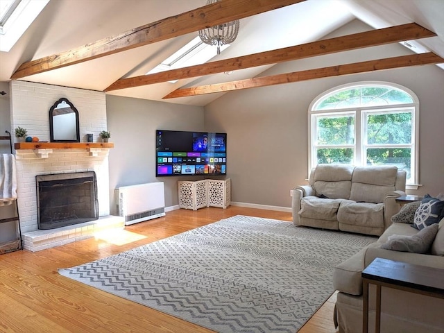 38 Pearson Dr, Newbury, MA 01922 - living room featuring a skylight, beamed ceiling, a fireplace, wood finished floors, and high vaulted ceiling