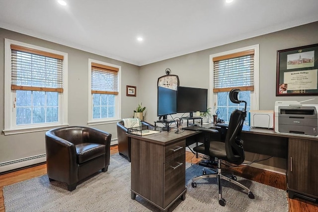 home office featuring light hardwood / wood-style flooring and baseboard heating