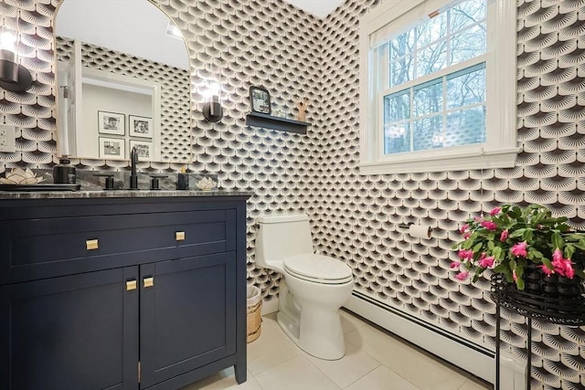 bathroom with vanity, a baseboard heating unit, tile patterned floors, and toilet