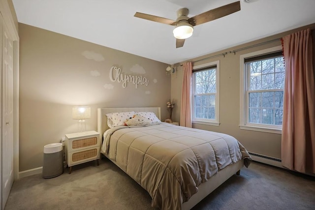 carpeted bedroom featuring baseboard heating and ceiling fan