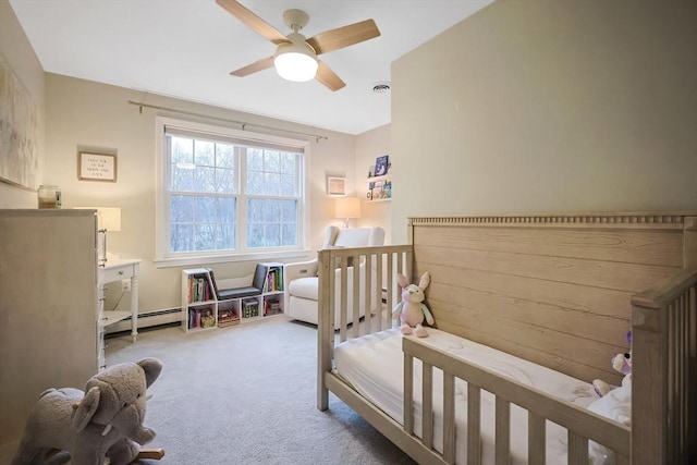 carpeted bedroom featuring a baseboard radiator and ceiling fan