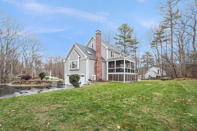 rear view of property with a sunroom and a yard