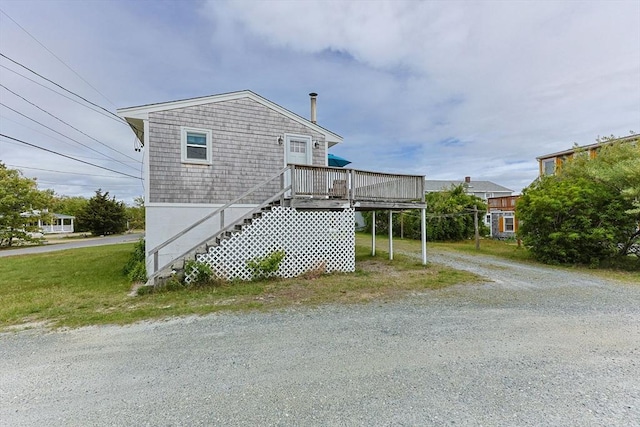 357 Phillips Rd, Sandwich, MA 02563 - view of property exterior featuring a wooden deck, stairs, and gravel driveway
