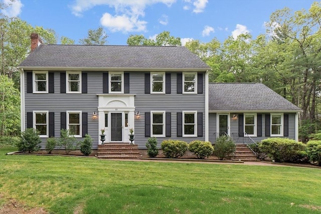 88 Carlton Ln, North Andover, MA 01845 - colonial home featuring a front yard, a chimney, and a shingled roof