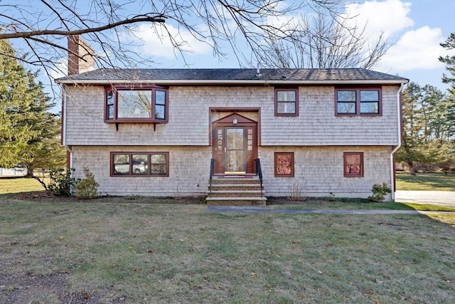 split foyer home with a front lawn