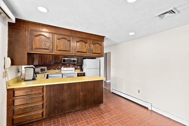 kitchen featuring white appliances, a baseboard radiator, and kitchen peninsula