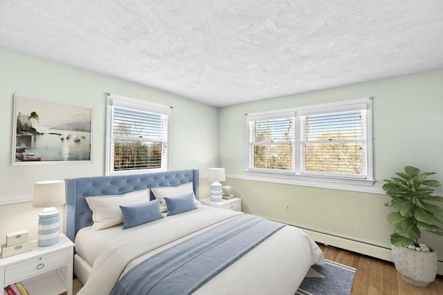 bedroom featuring dark wood-type flooring, multiple windows, and a textured ceiling