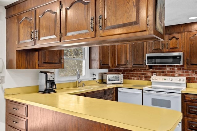 kitchen featuring sink and white appliances