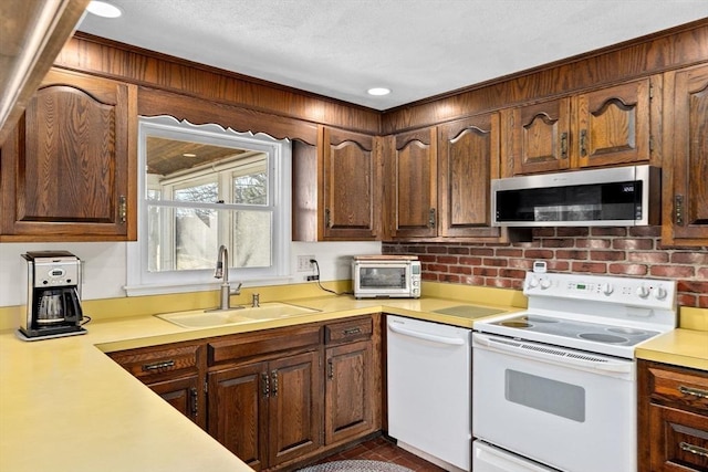 kitchen with sink and white appliances