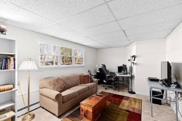 tiled living room featuring a drop ceiling and a baseboard heating unit