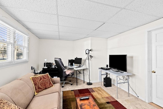 office area with a paneled ceiling