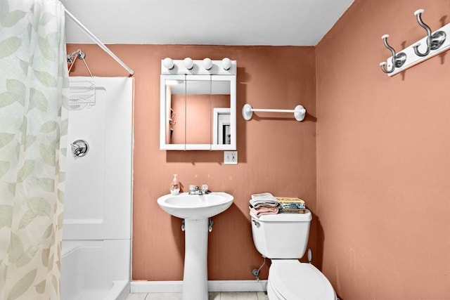 bathroom with tile patterned flooring, curtained shower, and toilet