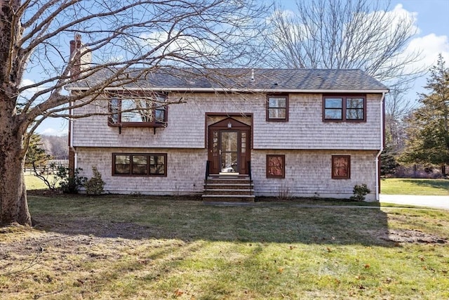 raised ranch with a front lawn